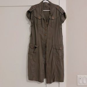 Light brown shirt dress with chest and side pockets. Above knee length.